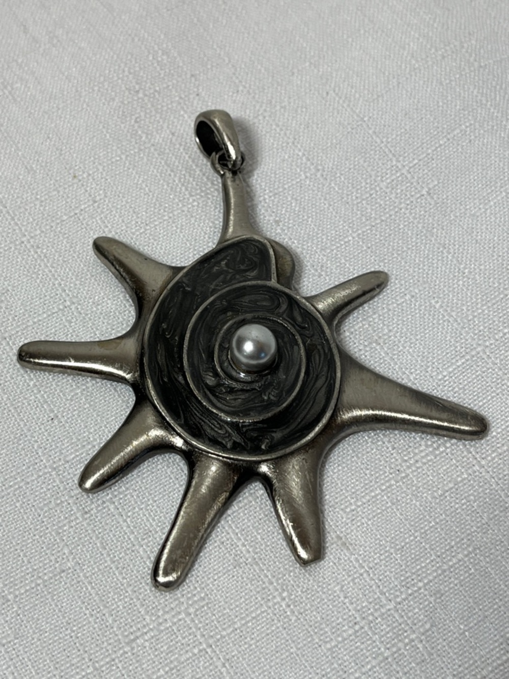 Vintage-style sun pendant, spiral shell design & a central pearl. Silver tone.